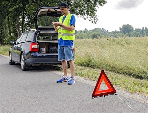 Avarinis trikampis pastatytas už automobilio
