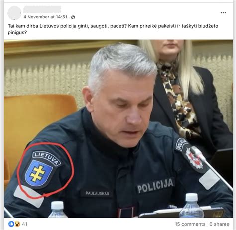 Teisingumo svarstyklių ir policijos skydo simbolis