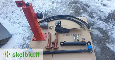 MTZ traktoriaus priekinis tiltas su hidrauliniu cilindru