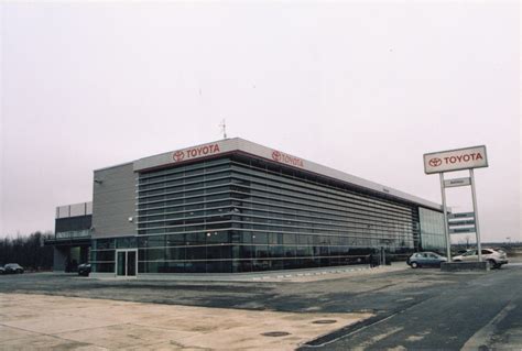 UAB AUTOTOJA logotipas ir pastato nuotrauka